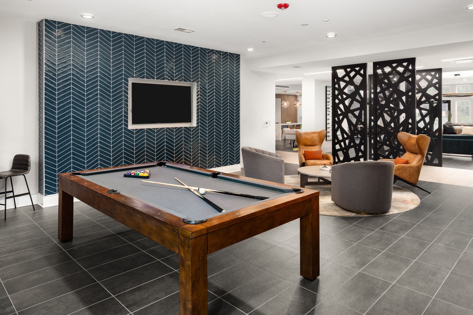 a games room with a pool table and a television